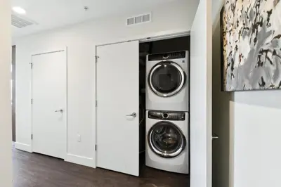 a laundry room with two washer and dryer at Rosé All Day | Espadin LoHi in Denver