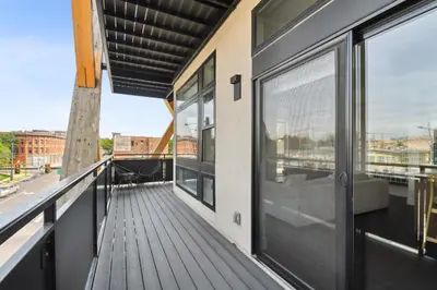 a balcony with a view of a building at Rosé All Day | Espadin LoHi in Denver