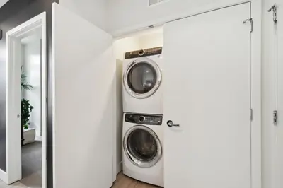a washer and dryer in a white laundry room at Moroccan Mood | Espadin LoHi in Denver