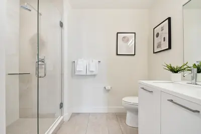 a white bathroom with a shower and a toilet at Moroccan Mood | Espadin LoHi in Denver