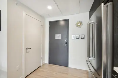 a hallway with a door and a refrigerator at Moroccan Mood | Espadin LoHi in Denver