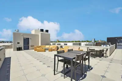 a patio with a table and chairs on a roof at Moroccan Mood | Espadin LoHi in Denver