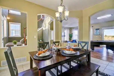 a dining room with a table and a piano at Lakeview - Gameroom - Pool Table in Henderson