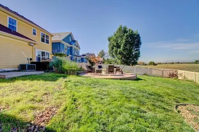 a yard with a house and a fence at Lakeview - Gameroom - Pool Table in Henderson