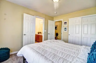 a bedroom with two white doors and a bed at Lakeview - Gameroom - Pool Table in Henderson