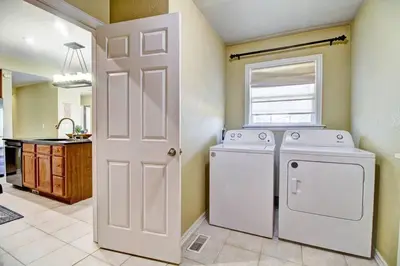 a laundry room with a washing machine and a window at Lakeview - Gameroom - Pool Table in Henderson