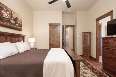 a bedroom with a bed and a dresser and a tv at Base Camp at Iron Horse,,, townhouse in Winter Park