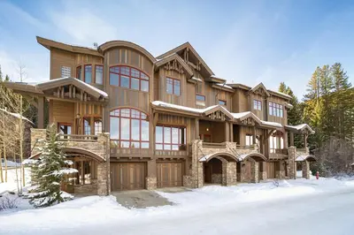 a large wooden house in the snow at Base Camp at Iron Horse,,, townhouse in Winter Park