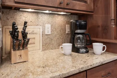 a kitchen counter with two cups and a coffee maker at Base Camp at Iron Horse,,, townhouse in Winter Park