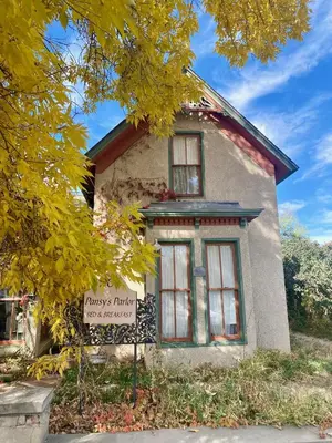 an old house with a sign in front of it at Pansy’s Parlor Bed & Breakfast in Golden