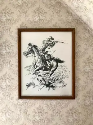 a framed drawing of a man riding a horse at Pansy’s Parlor Bed & Breakfast in Golden