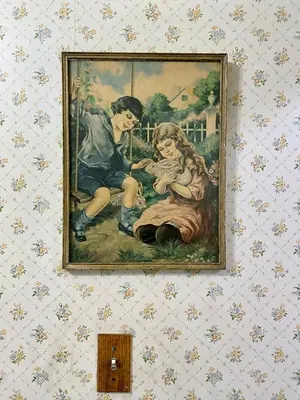 a painting of a boy and a girl on a wall at Pansy’s Parlor Bed & Breakfast in Golden