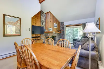 a dining room with a table and chairs and a couch at Updated Winter Park Condo with Indoor Heated Pool! in Winter Park