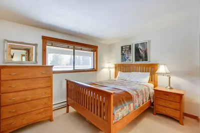 a bedroom with a bed and a dresser and a window at Updated Winter Park Condo with Indoor Heated Pool! in Winter Park