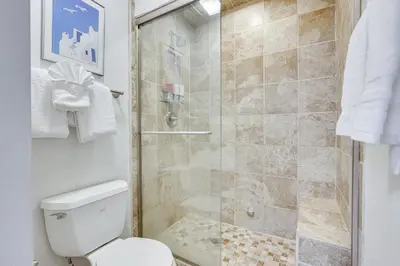 a bathroom with a shower with a toilet at Updated Winter Park Condo with Indoor Heated Pool! in Winter Park