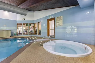 a large tub in a room next to a swimming pool at Updated Winter Park Condo with Indoor Heated Pool! in Winter Park