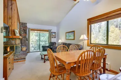 a living room with a wooden table and chairs at Updated Winter Park Condo with Indoor Heated Pool! in Winter Park