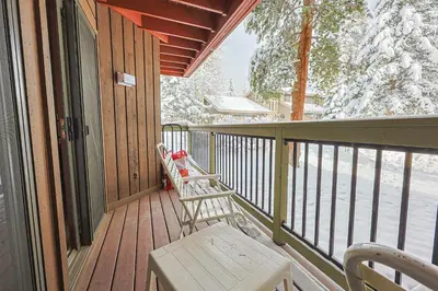 a porch with a bench and a snow covered tree at Wild Irishman 2 bed 2 bath retreat WIBH in Keystone