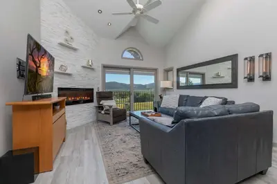 a living room with a couch and a fireplace at Lake Forest Lakeview Condo: Mountain Views, Close to Town in Frisco