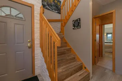 a staircase in a home with a white door at Lake Forest Lakeview Condo: Mountain Views, Close to Town in Frisco