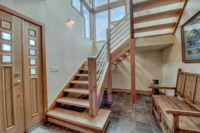 a wooden staircase in a house with a skylight at CoCo Chalet in Silverthorne