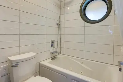 a bathroom with a toilet and a tub and a mirror at half Mi to Lake Dillon Mtn-View Condo in Frisco in Frisco