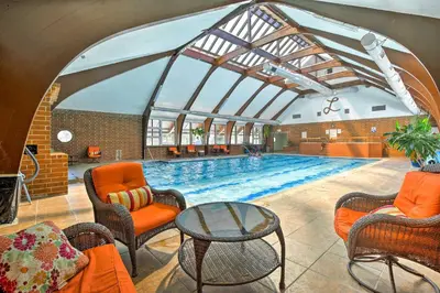 a large swimming pool with chairs and a table at half Mi to Lake Dillon Mtn-View Condo in Frisco in Frisco