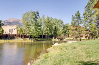 a view of a river with a building and trees at half Mi to Lake Dillon Mtn-View Condo in Frisco in Frisco