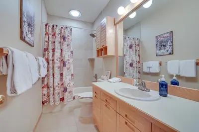 a bathroom with a sink and a toilet and a shower at Cozy Condo with Balcony and Mtn Views in Silverthorne in Silverthorne