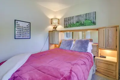 a bedroom with a bed with a purple blanket at Cozy Condo with Balcony and Mtn Views in Silverthorne in Silverthorne