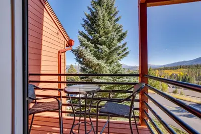a balcony with a table and chairs and a tree at Cozy Condo with Balcony and Mtn Views in Silverthorne in Silverthorne