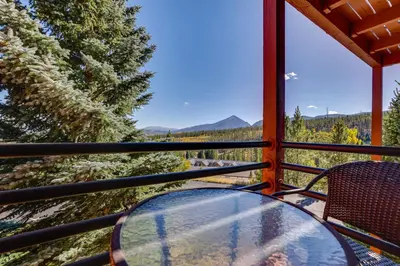 a glass table and chairs on a balcony with a view at Cozy Condo with Balcony and Mtn Views in Silverthorne in Silverthorne
