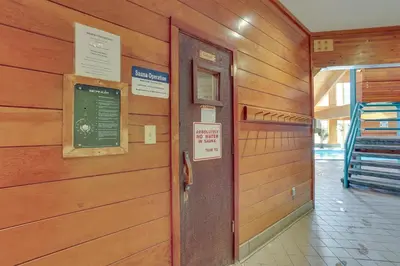 a wooden wall with a door and a sign on it at Cozy Condo with Balcony and Mtn Views in Silverthorne in Silverthorne