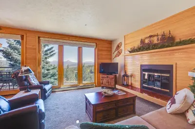 a living room with a couch and a fireplace at Cozy Condo with Balcony and Mtn Views in Silverthorne in Silverthorne