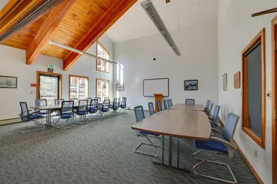 a conference room with tables and chairs in it at Cozy Condo with Balcony and Mtn Views in Silverthorne in Silverthorne