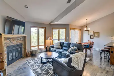 a living room with a couch and a fireplace at 6 Mi to Winter Park Mtn-View Condo with Balcony! in Fraser