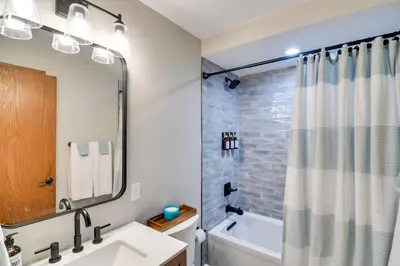 a bathroom with a tub and a sink and a shower at 6 Mi to Winter Park Mtn-View Condo with Balcony! in Fraser