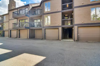 an empty parking lot in front of a building at 6 Mi to Winter Park Mtn-View Condo with Balcony! in Fraser