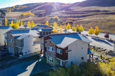 an aerial view of a house with a mountain in the background at Ski-InandSki-Out Granby Townhouse with Private Hot Tub in Granby