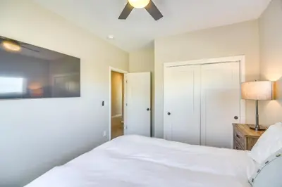 a bedroom with a bed and a ceiling fan at Ski-InandSki-Out Granby Townhouse with Private Hot Tub in Granby