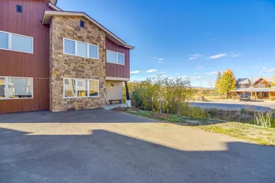 a building with a parking lot in front of it at Ski-InandSki-Out Granby Townhouse with Private Hot Tub in Granby