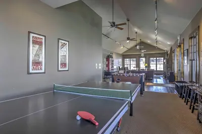 a room with a ping pong table in it at Ski-InandSki-Out Granby Townhouse with Private Hot Tub in Granby
