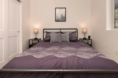 a bedroom with a purple bed with two lamps at New Condo! Skiboard Winter Park Shuttle in Fraser