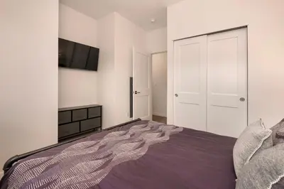 a bedroom with a bed and a tv on the wall at New Condo! Skiboard Winter Park Shuttle in Fraser