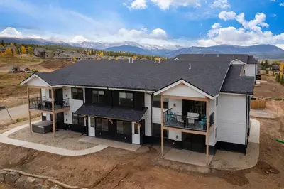 an aerial view of a house with mountains in the background at New Condo! Skiboard Winter Park Shuttle in Fraser