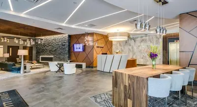 a lobby with a table and chairs in a room at Larimer Square, Parking included, at The Windsor in Denver