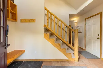 a wooden staircase in a house with a door at 1952 Northstar townhouse in Keystone