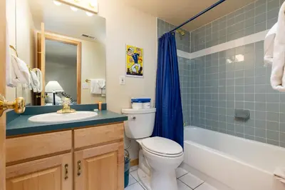 a bathroom with a toilet and a sink and a tub at 1952 Northstar townhouse in Keystone