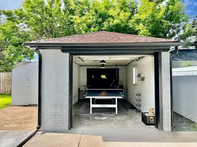a garage with a ping pong table in it at 3 Min Walk To Olde Town! Hot Tub, Fire Pit, Games! in Arvada