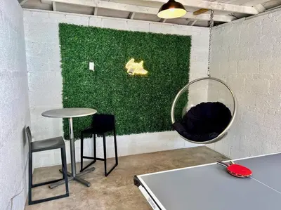 a room with a table and chairs and a mirror at 3 Min Walk To Olde Town! Hot Tub, Fire Pit, Games! in Arvada